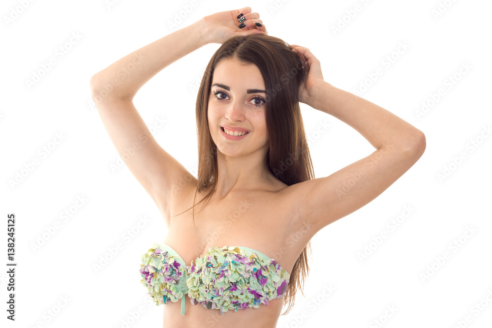 Adorable young sexy brunette woman with big natural breasts in swimsuit  with floral pattern smiling and looking at the camera isolated on white  background Stock Photo | Adobe Stock