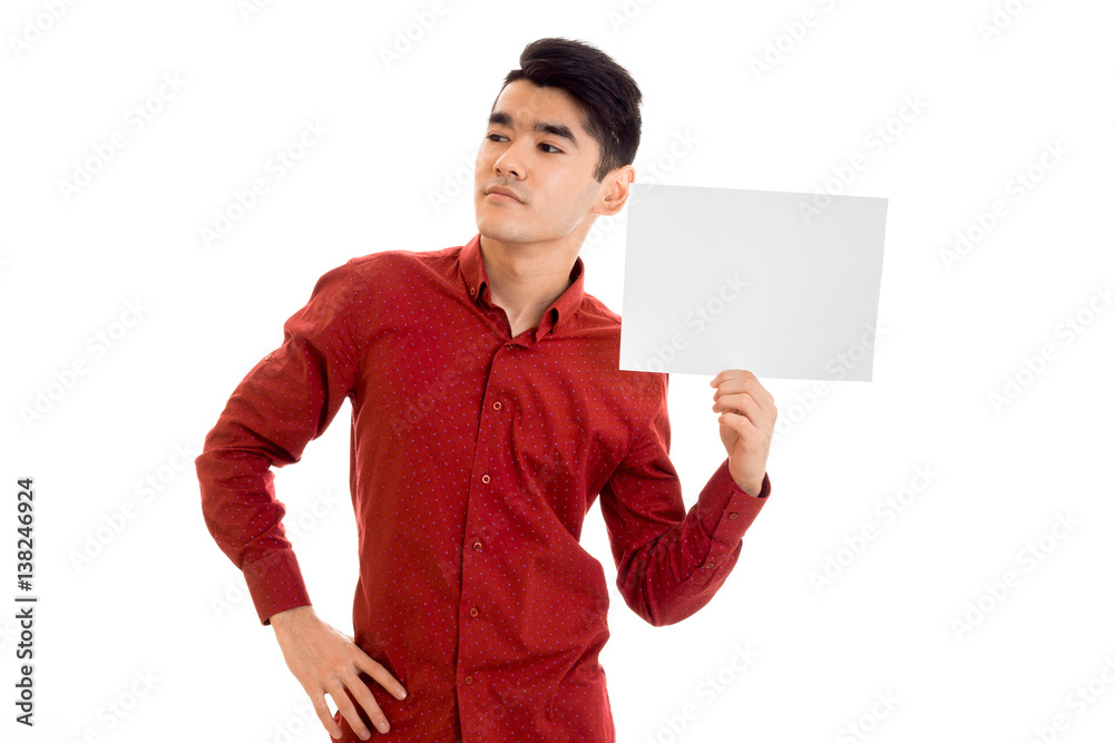 handsome young stylish male model posing in red shirt with empty placard isolated on white background handsome young stylish male model posing in red shirt with empty placard isolated on white background