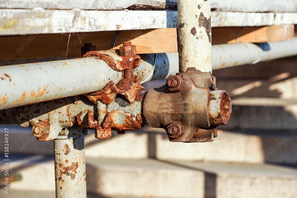 Detail of a steel scaffolding joint on construction site, Construction clamp Detail of a steel scaffolding joint on construction site, Construction clamp