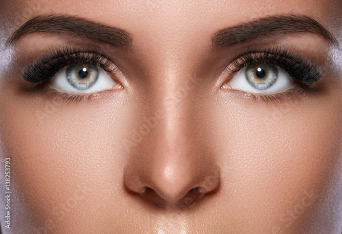 Female face with beautiful eyebrows and artificial eyelashes