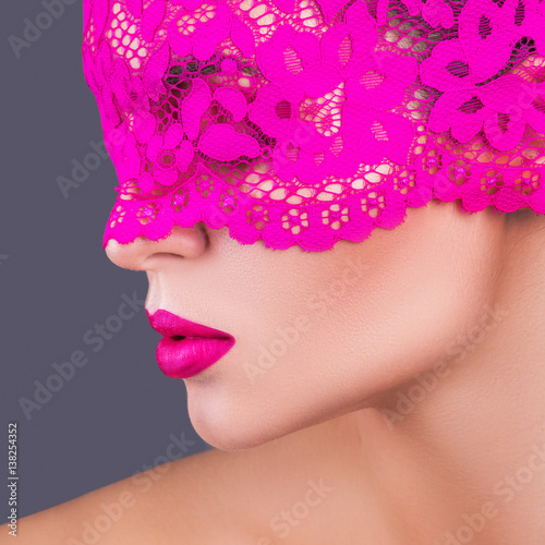 Woman with a pink blindfold on her face © blackday