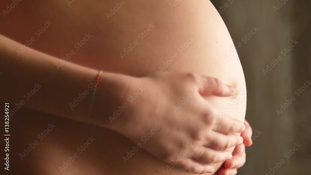 Mom and dad hands on pregnant tummy. Pregnant couple caressing pregnant belly. Expectant mother care. Maternity concept. Pregnancy. Happy family. Slow motion 60 fps. Hd 1080p. High speed camera Mom and dad hands on pregnant tummy. Pregnant couple caressing pregnant belly. Expectant mother care. Maternity concept. Pregnancy. Happy family. Slow motion 60 fps. Hd 1080p. High speed camera