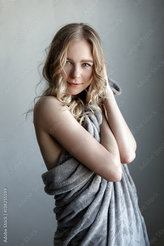 Fototapeta premium portrait of young sexy woman posing near the gray wall