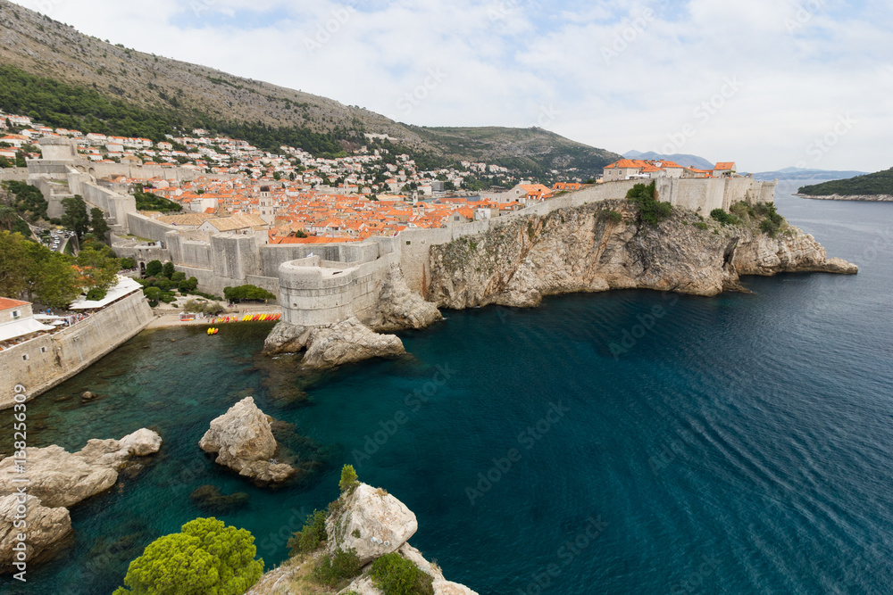 View of Mediterranean Sea, Old Town and City Walls on a steep cliff in Dubrovnik, Croatia.