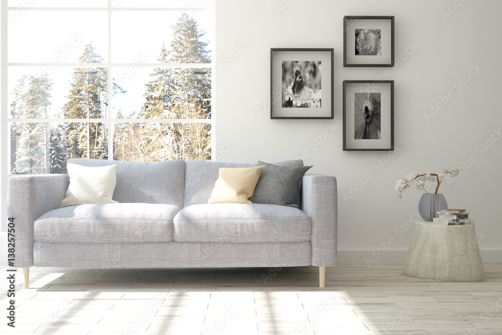 Fototapeta premium White room with sofa and winter landscape in window. Scandinavian interior design