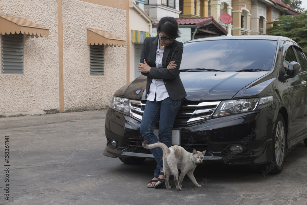 Portrait of a pretty woman, with a car and a cat