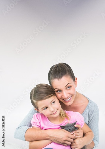 Mother and Daughter Hugging against a neutral background
