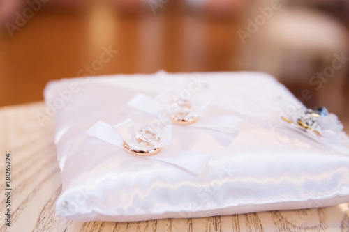 Gold wedding rings on the pillow