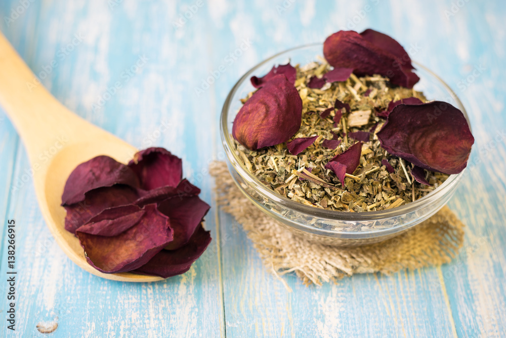 Herbal tea with rose petals on a rustic table. Herbal tea with rose petals on a rustic table.