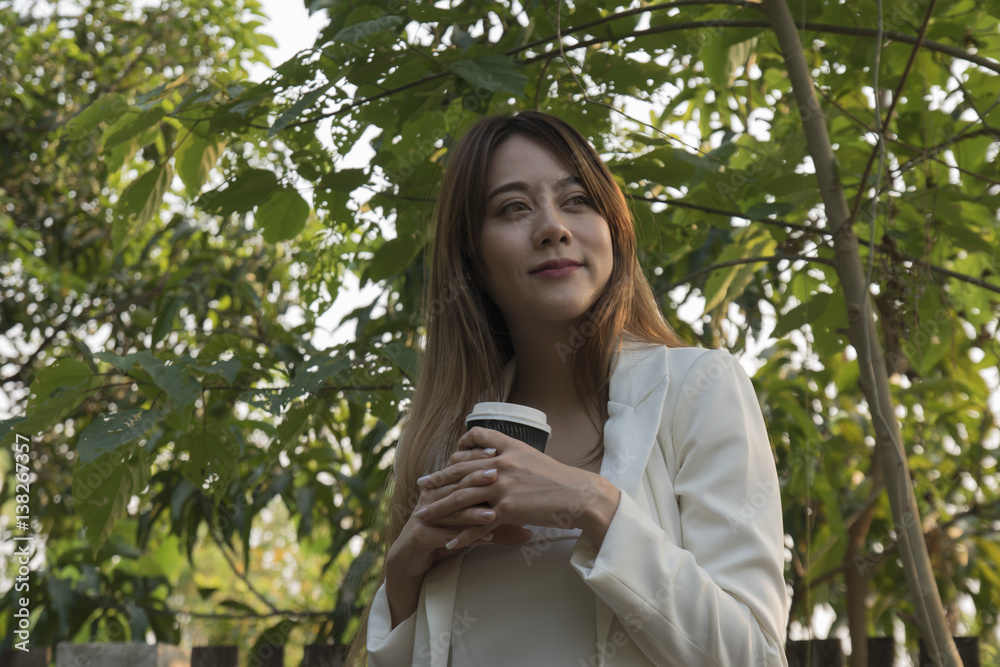 Takeaway coffee beautiful young white woman in a park in the fall with a cup of coffee, smiling. Takeaway coffee beautiful young white woman in a park in the fall with a cup of coffee, smiling.