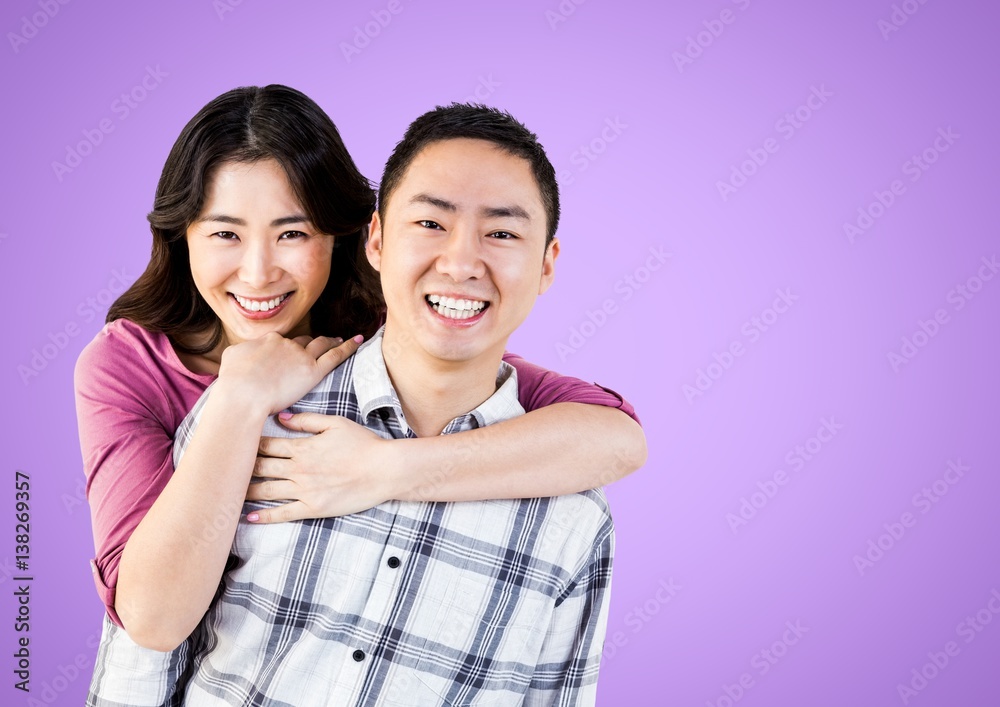 Portrait of a Happy Couple smiling against a purple Background Portrait of a Happy Couple smiling against a purple Background