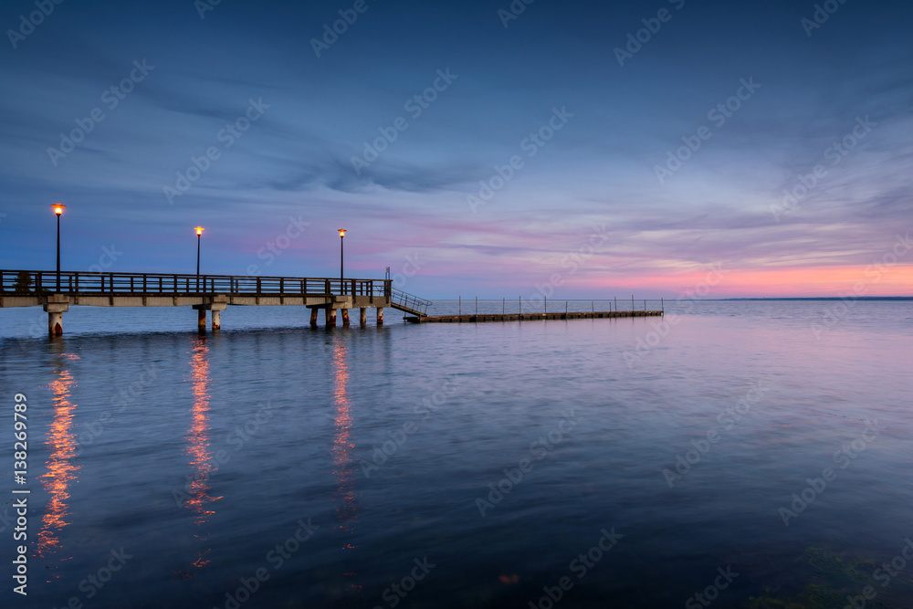 Wooden pier in Kuznica at dusk. Baltic Sea. Poland.	
