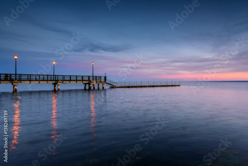 Wooden pier in Kuznica at dusk. Baltic Sea. Poland.   