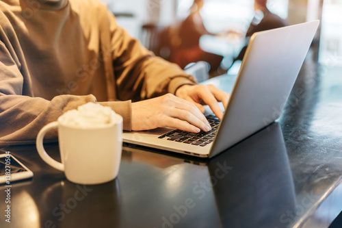 Freelance specialist working working on a new project in coworking, Professional businessman typing text on his modern laptop, Workplace in the early morning, Shallow DOF
