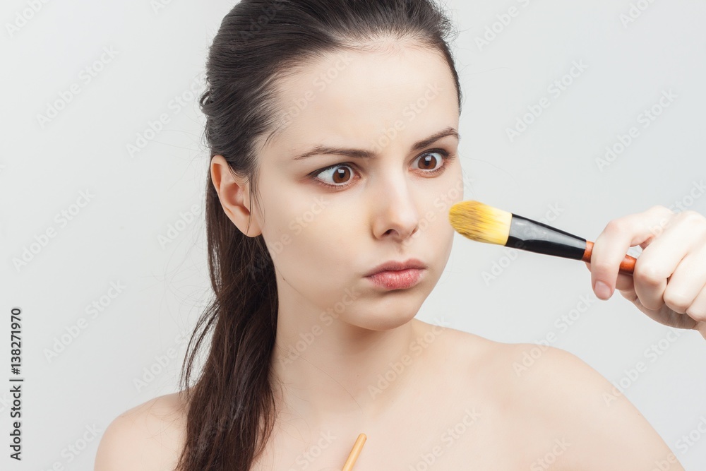 Fototapeta premium woman looking at makeup brush