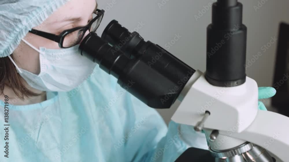 Close up view of scientist eye in glasses looking at microscope. Close up view of scientist eye in glasses looking at microscope.