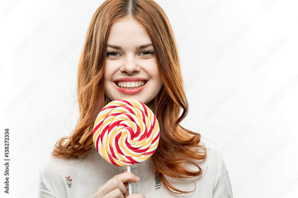 red and white lollipop in female hands