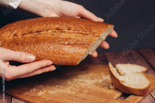 loaf on female hands, board