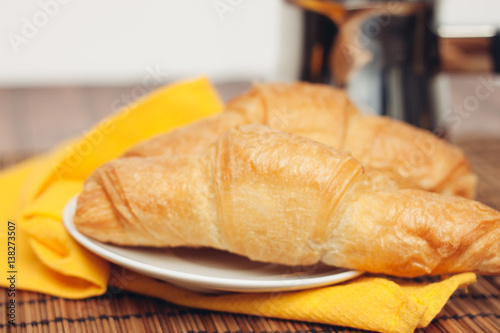 croissants in a plate yellow napkin