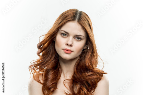 cute woman with bare shoulders on a light background