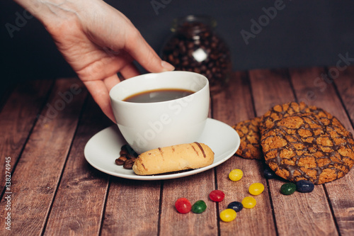 cup with a drink, shortbread and oatmeal cookies, colorful candy