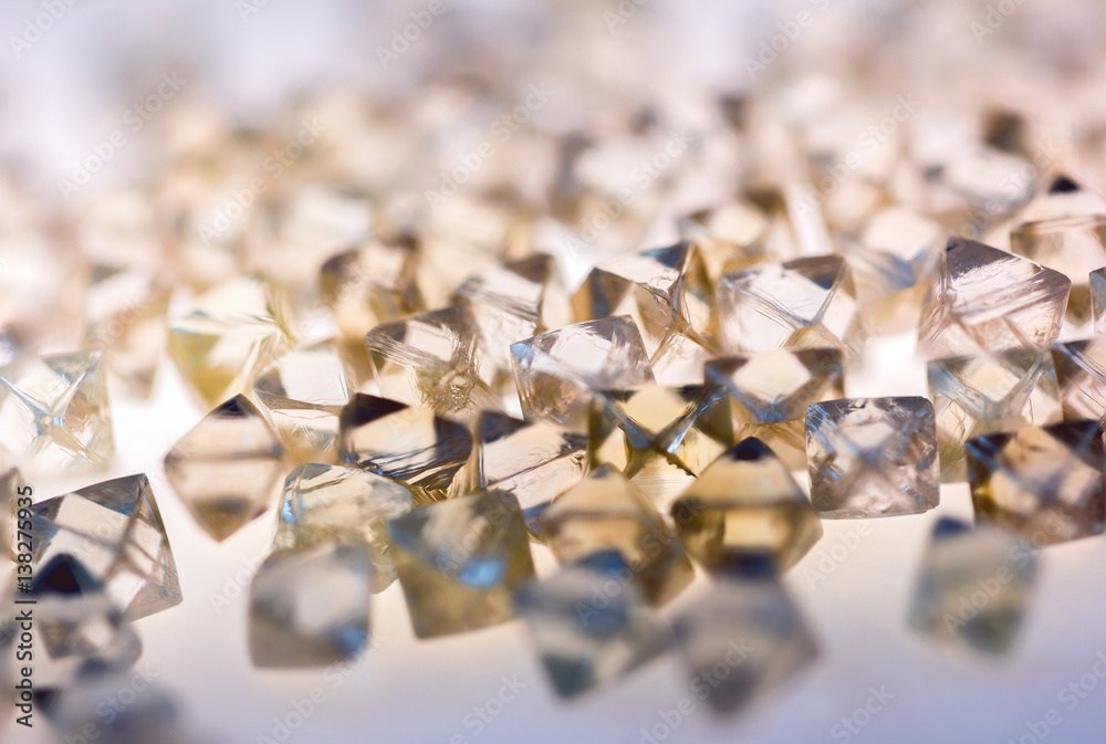 natural transparent diamonds in macro with yellow reflection natural transparent diamonds in macro with yellow reflection