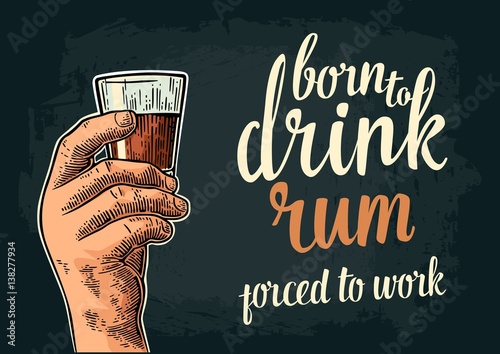 Male hand holding glass rum. Born to drink