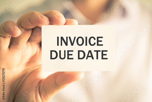 Businessman holding INVOICE DUE DATE message card