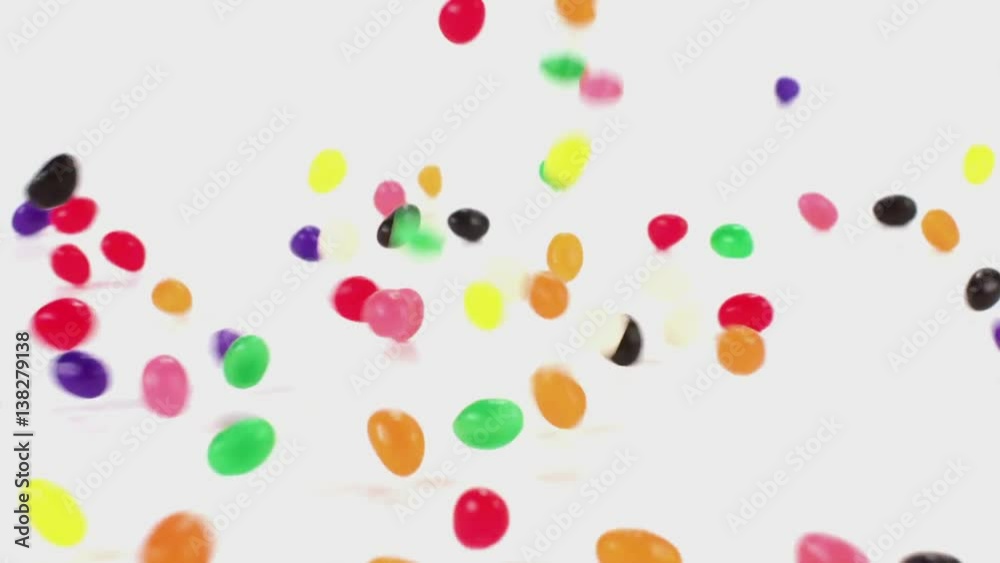 Jelly beans fall in slow motion onto a white cyc Jelly beans fall in slow motion onto a white cyc
