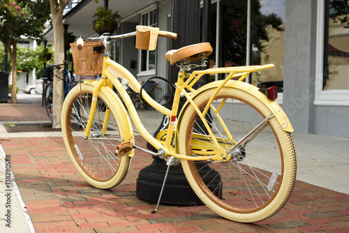 Yellow bicycle on downtown sidewalk on Saturday morning