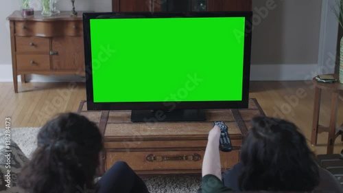 Green screen big screen with two young ladies in the foreground