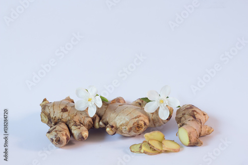 Root ginger on a blue studio background