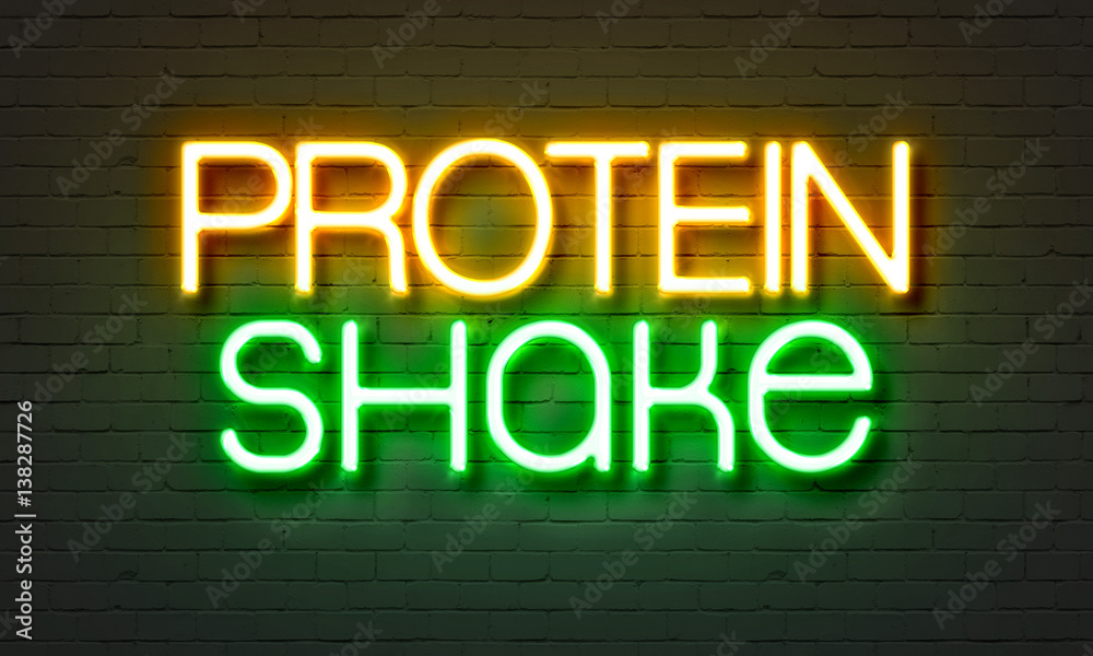 Protein shake neon sign on brick wall background.
