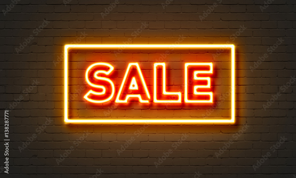 Obraz premium Sale neon sign on brick wall background.