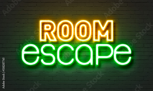 Room escape neon sign on brick wall background.