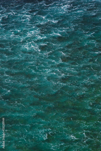Indian ocean texture. Turquoise sea water with white foam. Powerful and peaceful nature concept.