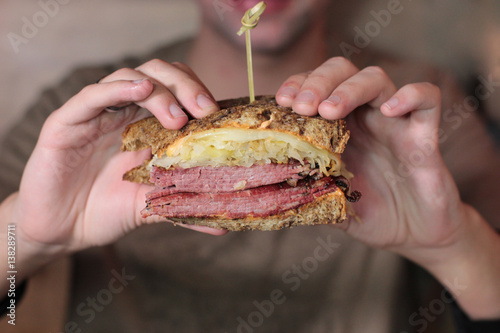 A photo of a man eating a sandwhich