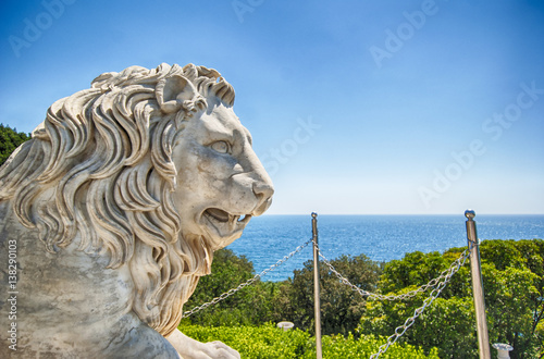 Marble lion statue in front of facade of Vorontsov palace in Crimea Russian Federation photo