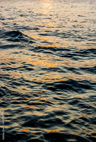 Small waves in the ocean at sunset