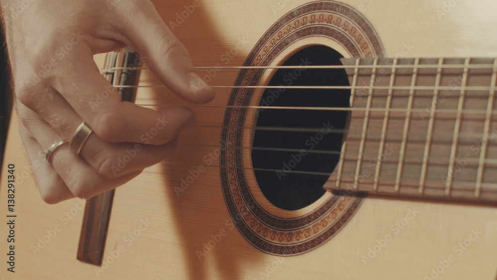 Fototapeta premium Hands of guitarist playing a guitar