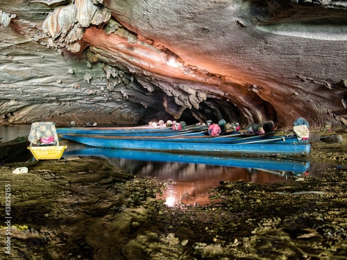 Long tail boats inside konglor cave in Laos
