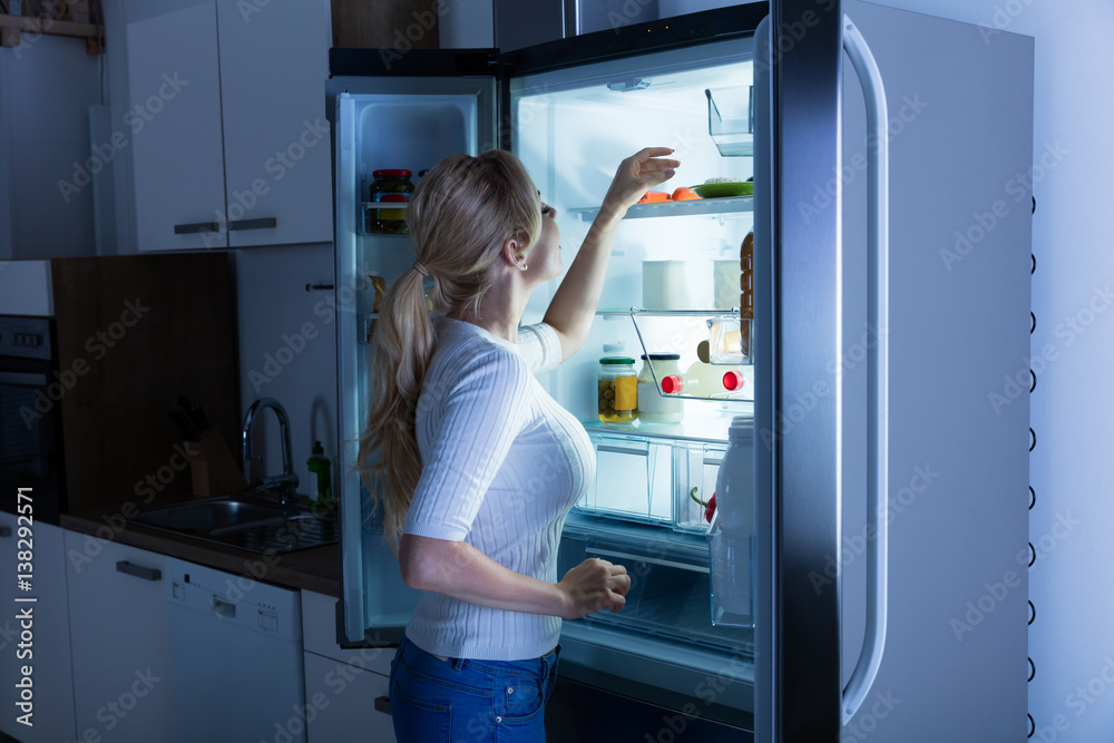 Woman Searching For Food In Refrigerator Woman Searching For Food In Refrigerator