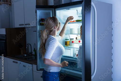 Woman Searching For Food In Refrigerator
