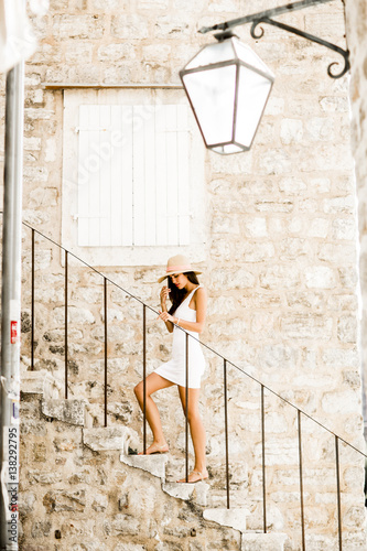 Young woman with hat standi...
