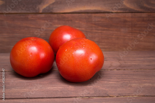 tomatoes on the wooden background with empty copyspace