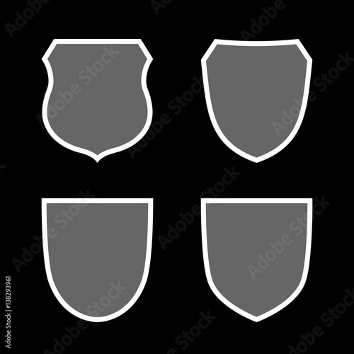 Shield shape icons set. Gray label signs isolated on black background. Symbol of protection, arms, security, safety. Flat retro style design. Element vintage heraldic emblem Vector illustration