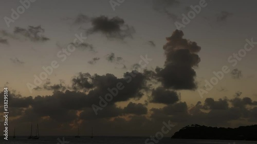 Time lapse of saliboats in harbor at sunset photo