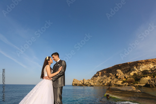 Bride and groom near the sea
