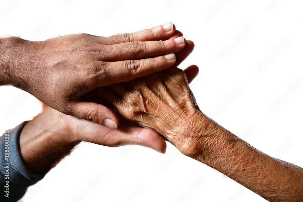 Fototapeta premium Hands of an aged woman holding the hand of a young man in isolated white background