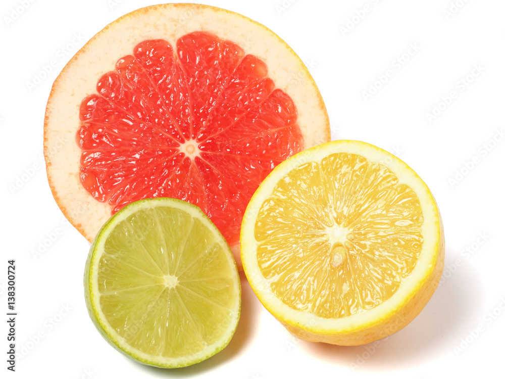 Slices grapefruit and lemon on white Slices grapefruit and lemon on white
